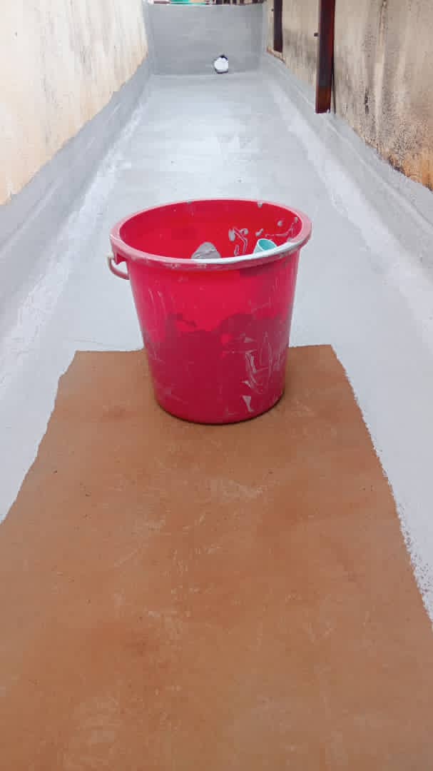 Ground-level concrete drainage channel after fresh grey waterproof coating was applied