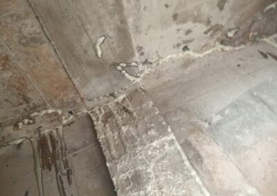 Cured polyurethane resin visible bulging from a crack line at a structural joint after PU injection repair