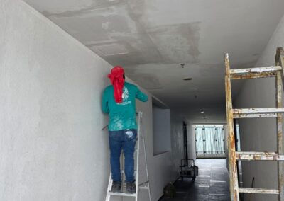 Water stain on a condominium corridor ceiling caused by a leaking concrete slab crack above, before repair