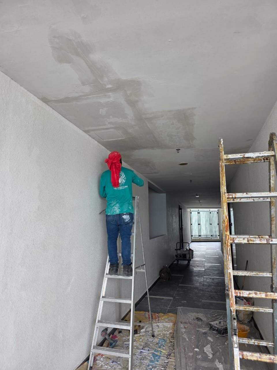 Water stain on a condominium corridor ceiling caused by a leaking concrete slab crack above, before repair
